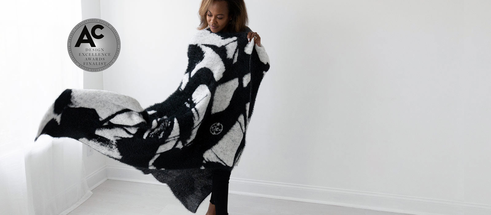BIG LOViE Dream microchennile and feather thread Jumper Maybach artist White Winds blanket with Accessories Council Design Excellence Award Finalist medallian, wrapped around woman