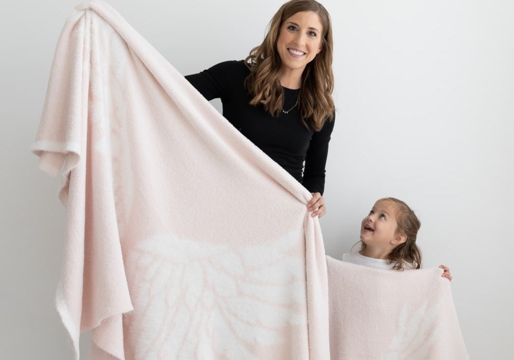 Mom and daughter holding BIG LOViE Dream Collection Wings Blankets Pink Big and Little.