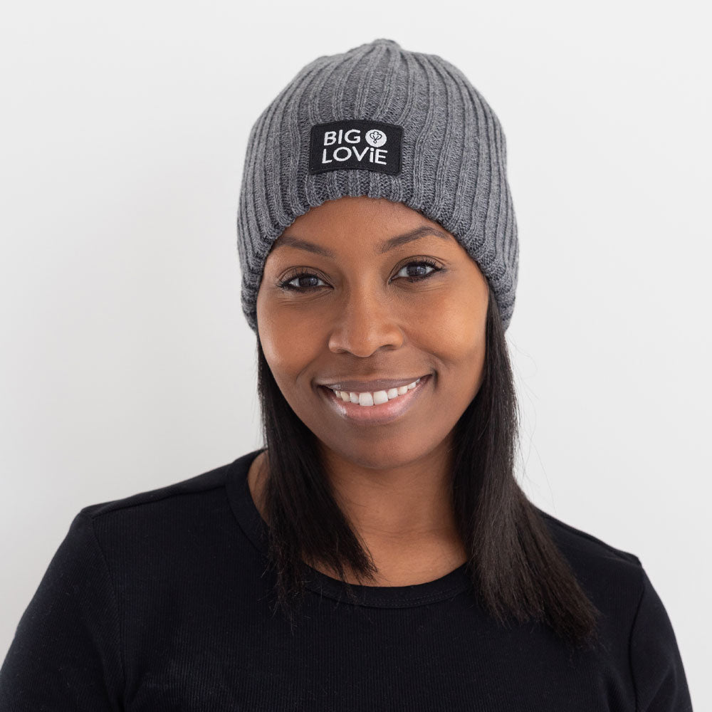 BIG LOViE Let the Fun Begin Gray Beanie with logo label on smiling woman
