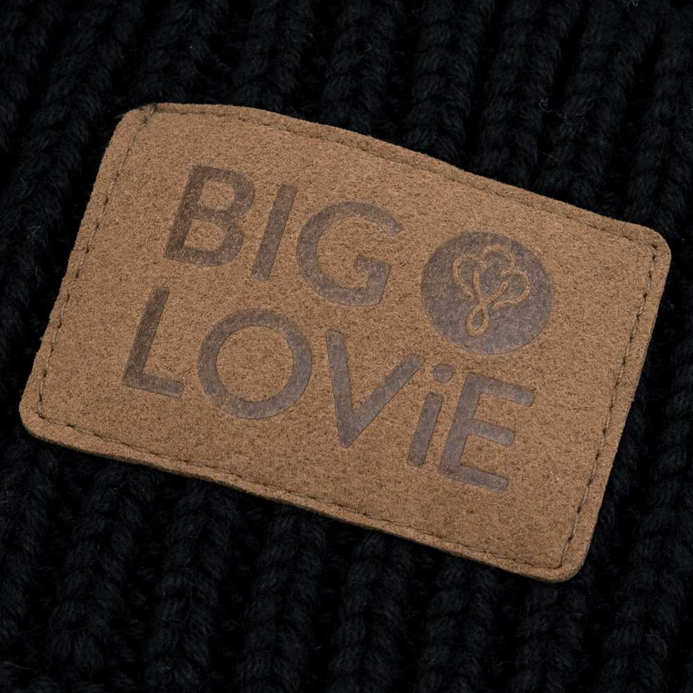 BIG LOViE Vibe Black Cotton Cashmere Hat with Pom, closeup of embossed faux logo label