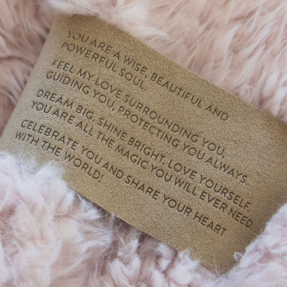 Close up of a Love Snap label with text,  on a Dusty Pink Guardian Angel Blanket