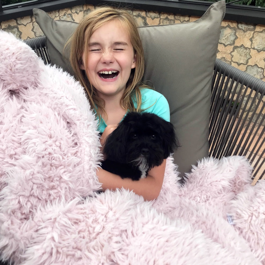 Young girl laughing holding a black dog, Little Guardian Angle Blanket in Dusty Pink, child size blanket, llama fabric