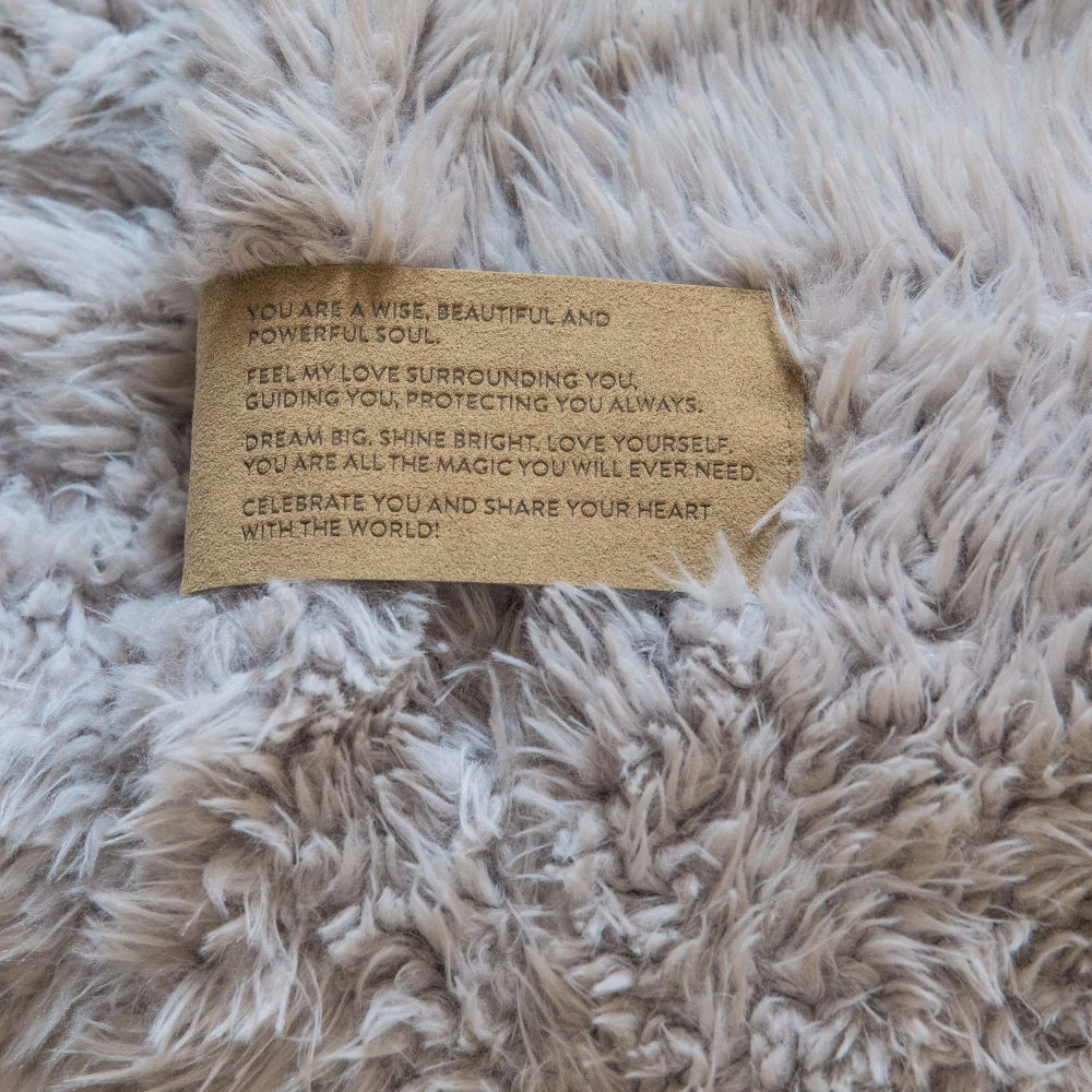 Close up of a Love Snap label with text, on a Silver Cloud Guardian Angel Blanket